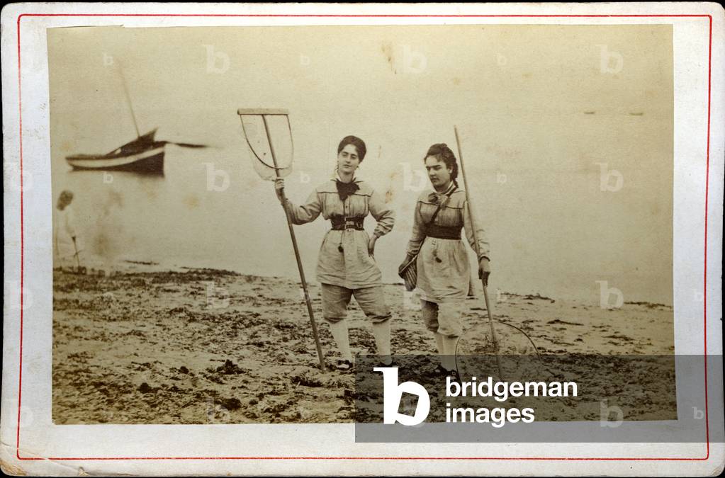 On the Atlantic coast, two women in shrimp fishing equipment, 1870