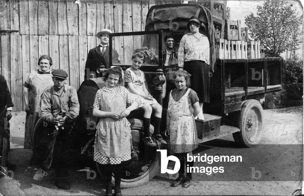 France: Truck driver and family pose with bottle load in Ford truck, 1913