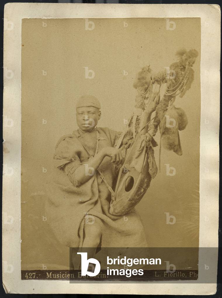 Barbarin musician playing a local instrument, 1870