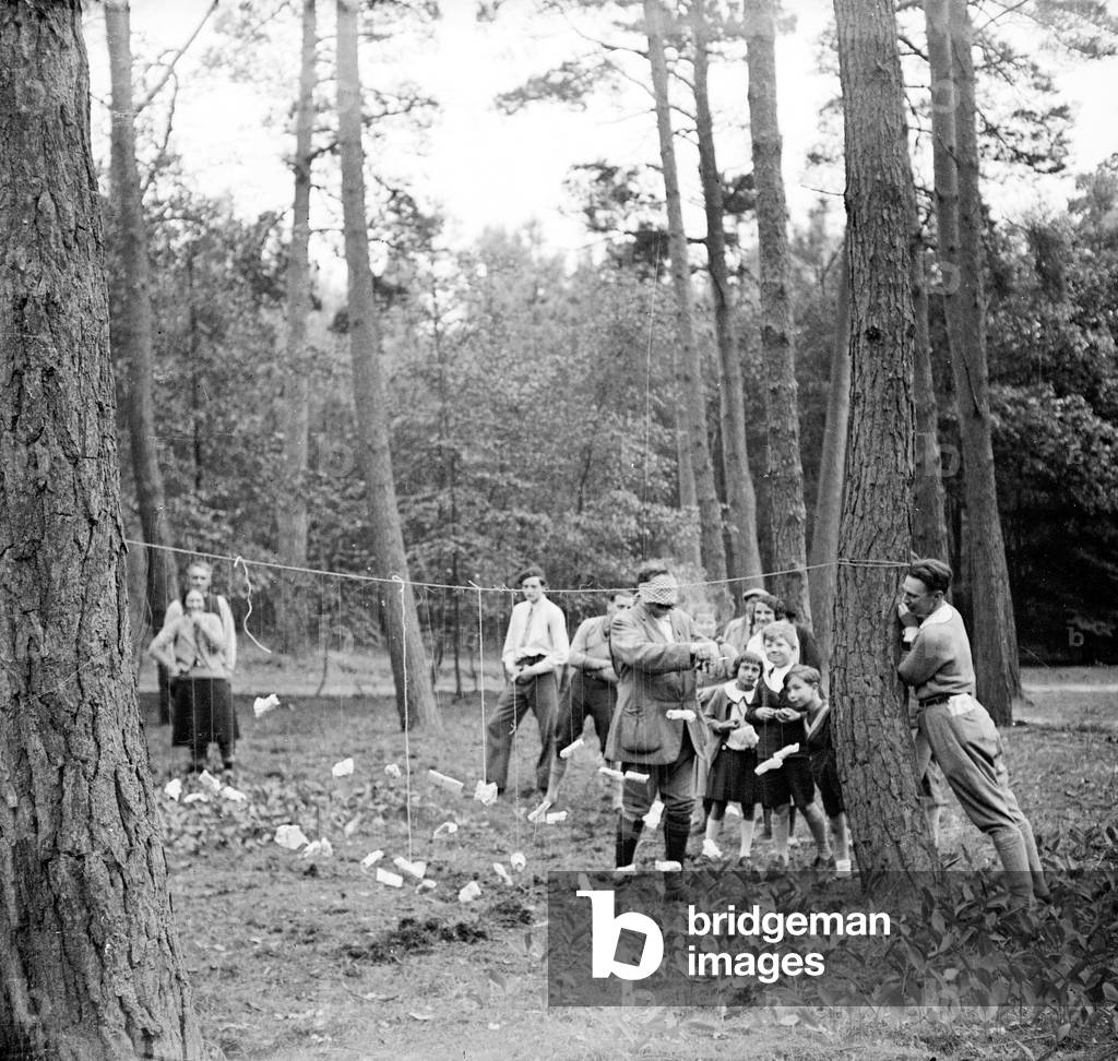 France, Pays de la Loire, Vendee (85), Les Sables-d'Olonnes: in a pine forest, collective game, a man cuts a string or a lot is attached to it, 1936