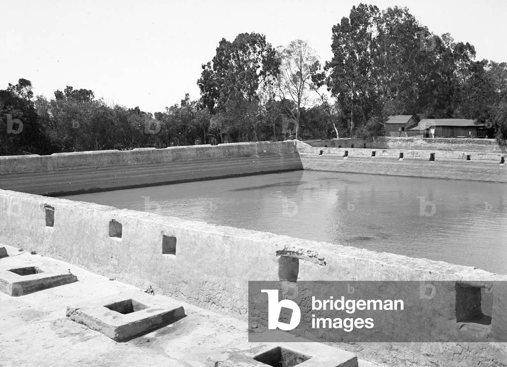 Tunisia, Sfax: The Teskia of the city. Original water distribution system from rainwater recovered in a reservoir. Animated view with Tunisians recuperating water in a well, 1900