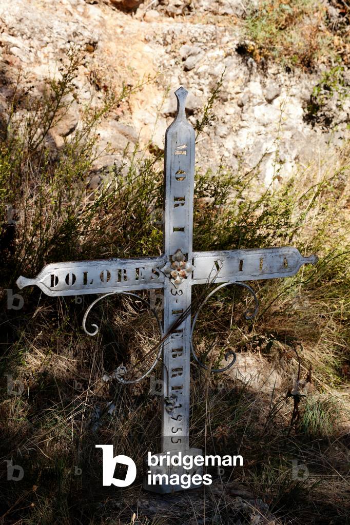 Castell-llebre. Church (Església de Mare de Déu). The churchyard. An iron cross.
