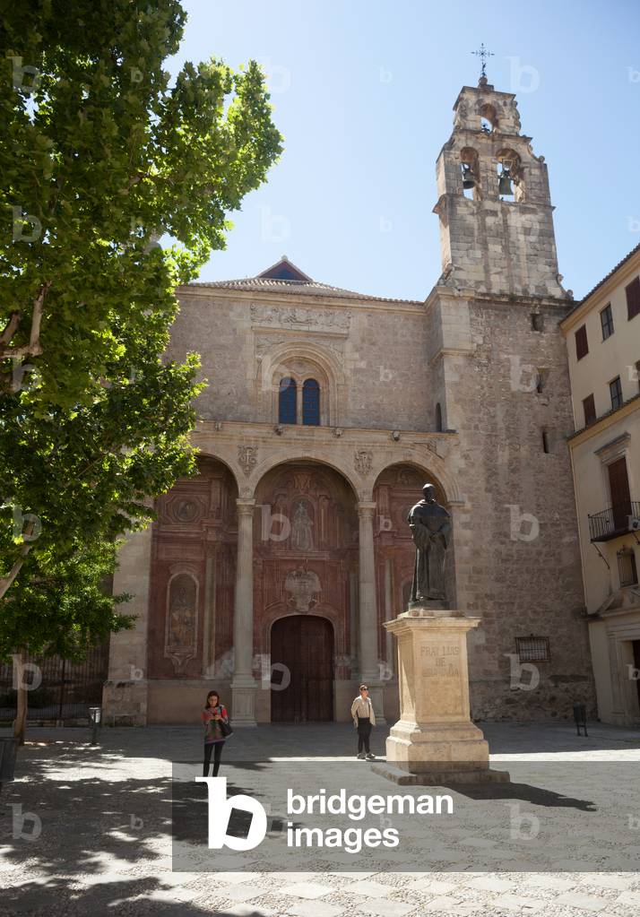 Square (Plaza de Santo Domingo). Church (Santo Domingo). West façade. People walking on the square.