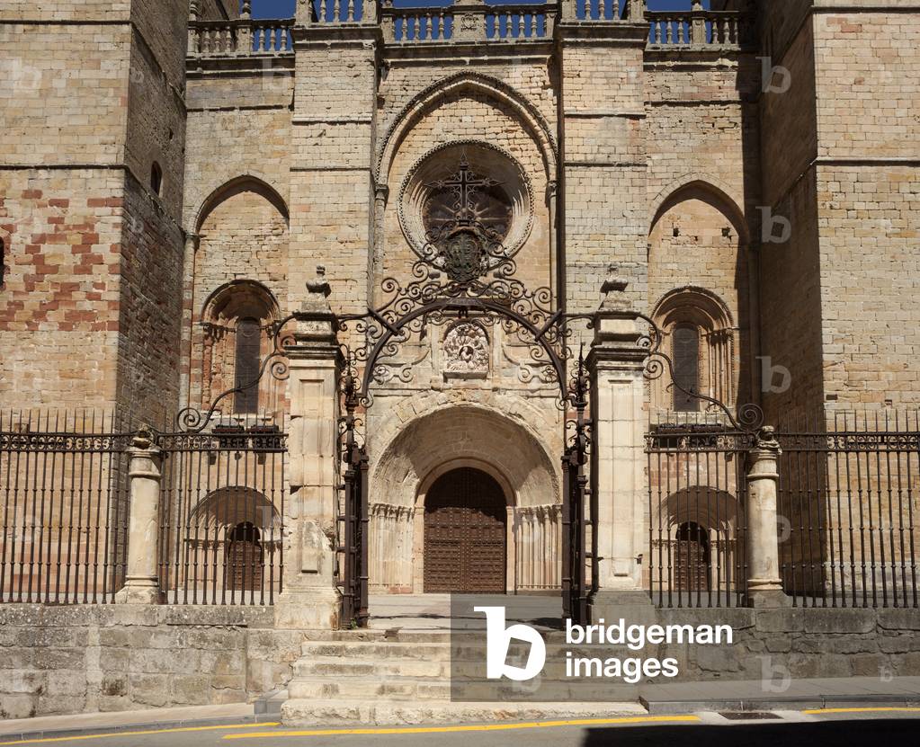 The cathedral. Exterior. West façade, Gothic. The portals, romanesque. The inner court fence, baroque.