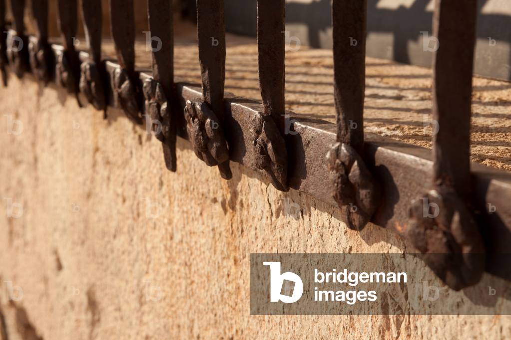 The main square (La Plaza Mayor). Palace (Palacio de los Condes, Palacio Ducal de Medinaceli). Façade. Detail. A fence. Ironwork.