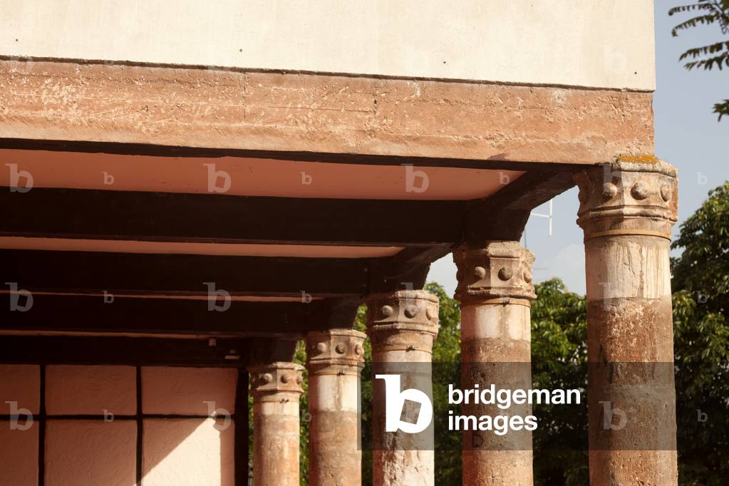 Detail of a house. Columns supporting the gallery.
