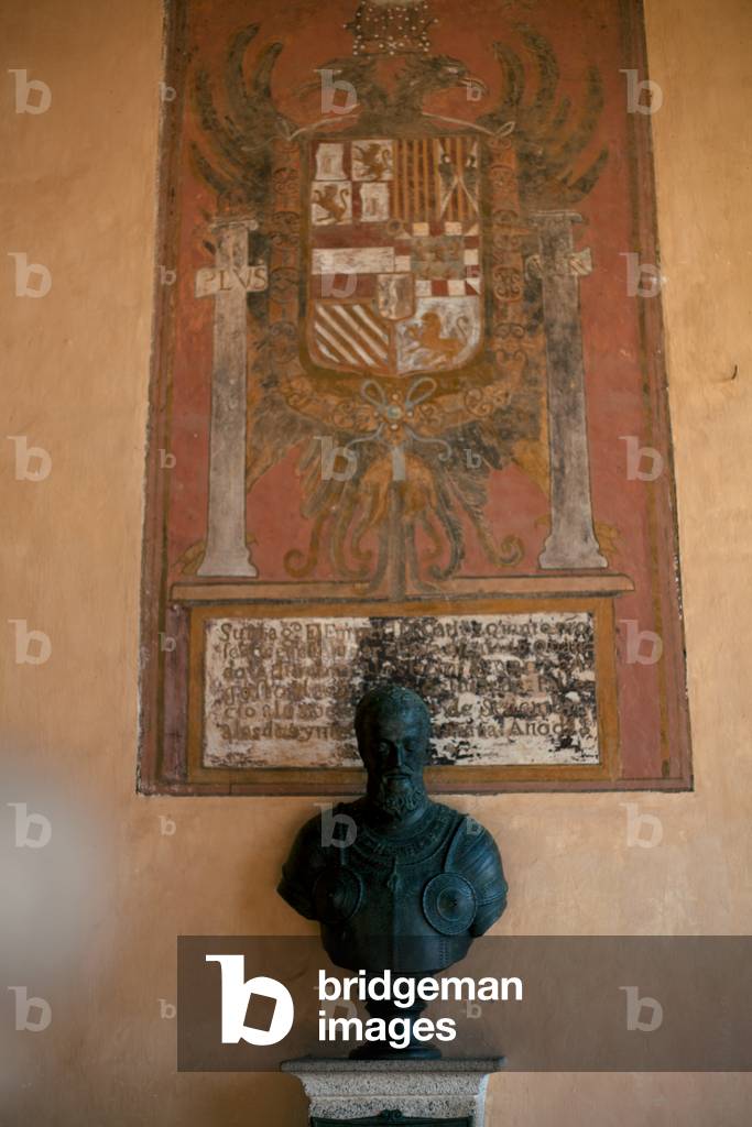 Monastery of Yuste. Gallery to the gardens. A bust of Charles Vth. Bronze. Wall painting with his escutheon.