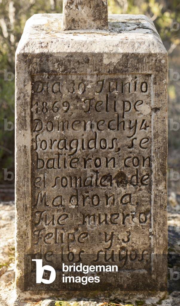 A memorial cross, named corss of the bandits ( Creu dels Lladresà). Text (dia 30 junio 1869, Felipe Domenechyl foragidos, se batieron con el somaten ? de Madrona Fue mueio Felipe y 3 de los suyos). Mid 19th century.