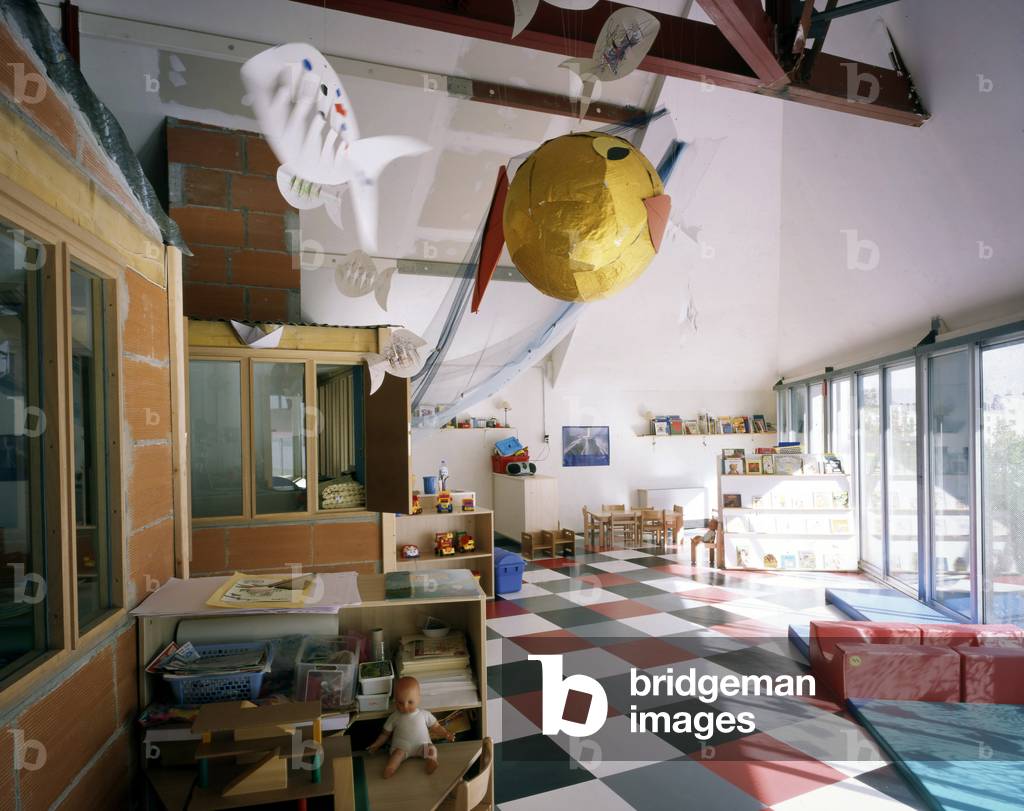Creche du Lieu Unique in Nantes. Architecture by Patrick Bouchain, 1999. Destined for the manufacture of biscuits, the Lefevre-Utile factory was built at the beginning of the 20th century on the edge of the Saint-Felix Canal using modern techniques. Two Art Nouveau towers designed by Auguste Bluysen were added in 1909. The workshops were active until the beginning of the 1970s and in 1986 the factory was definitively closed. The tower was restored in 1998 by Jean-Marie Lepinay. And Patrick Bouchain will carry out the renovation while keeping the spirit of the place, that of a factory spontaneously transformed into a cultural place. Photography 2000