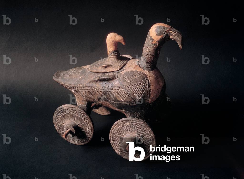 Duckling-shaped vase on two wheels, (pottery)