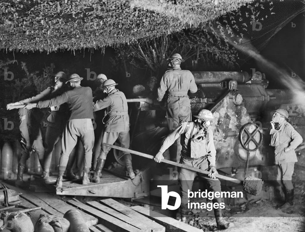 The 2nd Australian Siege Battery (55th Australian Siege Artillery Battery) working on a 9.2 inch Howitzer in their gas masks during an attack at Voormezeele, 15 September 1917 (b/w photo)