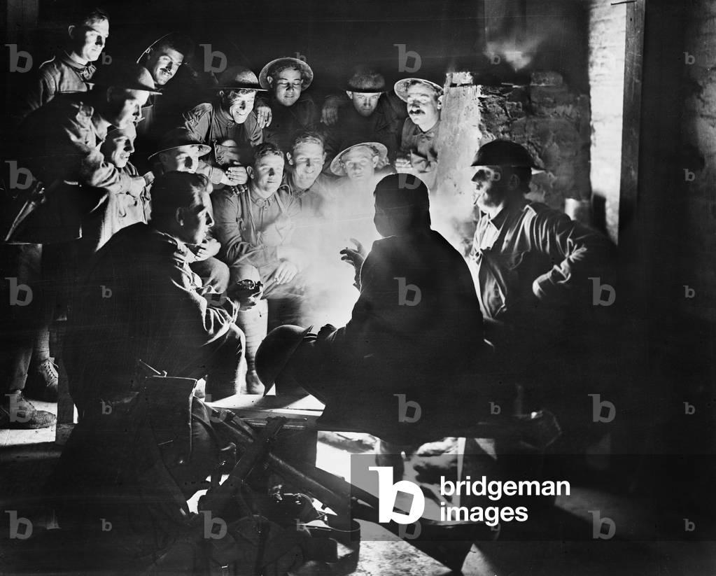 Members of the 1st Australian Light Trench Mortar Battery, 1st Australian Division listening to 