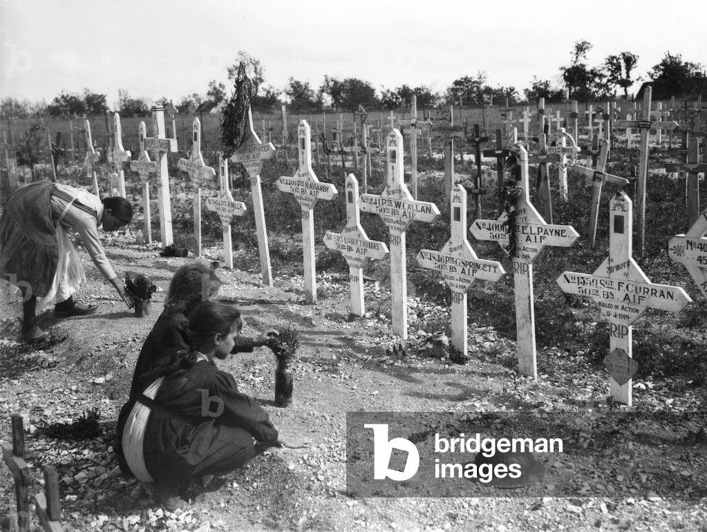 French children tending graves at Adelaide Cemetery of Australians killed in battle on the Western Front, Villers-Bretonneux, France 26 August 1919 (b/w photo)