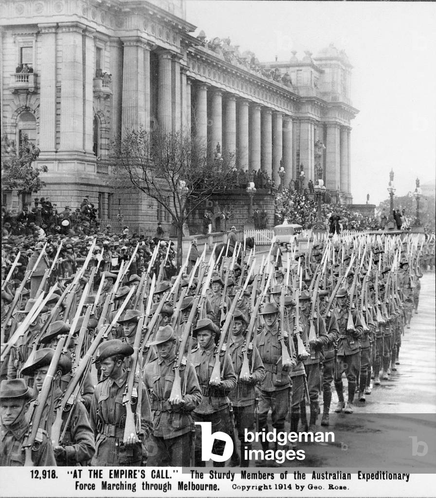 Men of the AIF marching past the Town Hall in Melbourne, Vic, their rifles, with bayonets fixed, are over their shoulders, prior to embarkation for overseas service, c. August 1914 (b/w photo)
