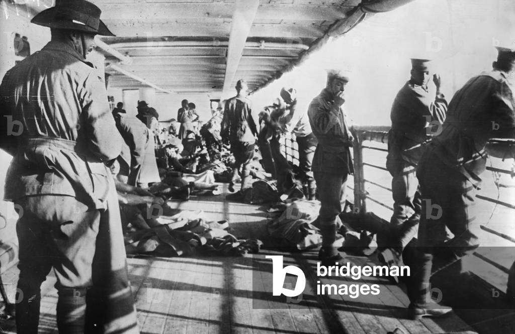 Men of the 3rd Battalion relaxing on the deck of the transport SS Derfflinger just before reveille on the morning before the landing at Anzac Cove, 24 April 1915 (b/w photo)
