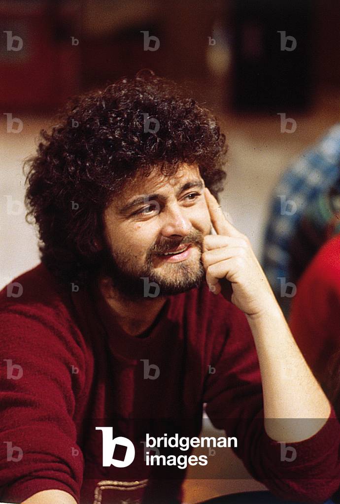 The comedian Beppe Grillo smiling, 1981 (b/w photo)