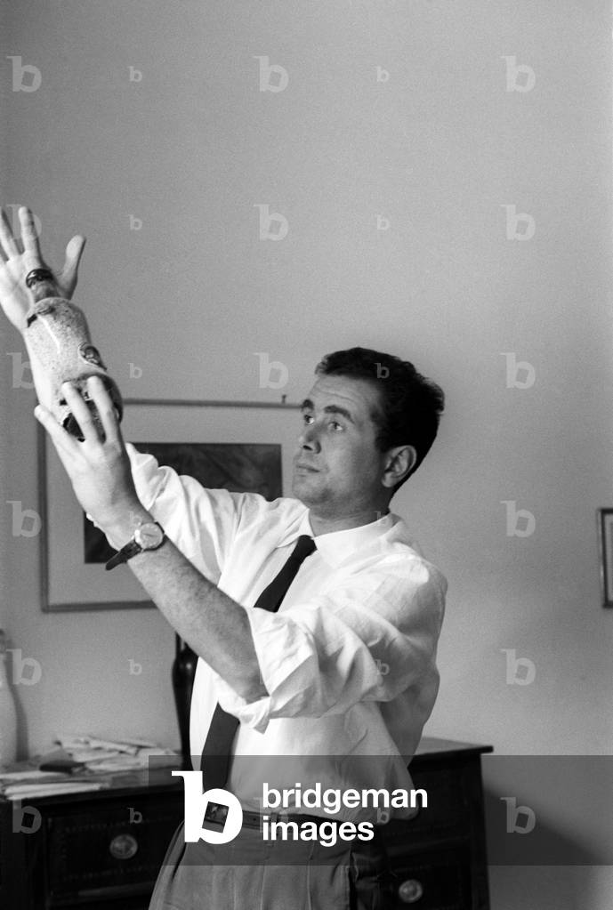 Enza Tortora raises and observes a bottle