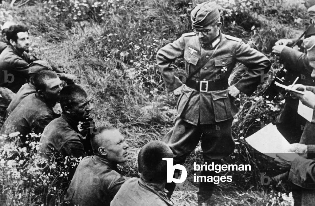 An officer interrogating some prisoners