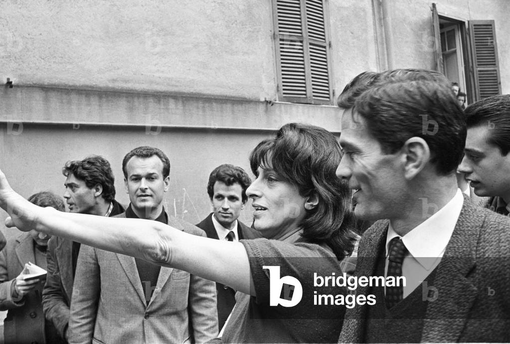Anna Magnani and Pier Paolo Pasolini surrounded by curious people, Italy, 1962 (b/w photo)