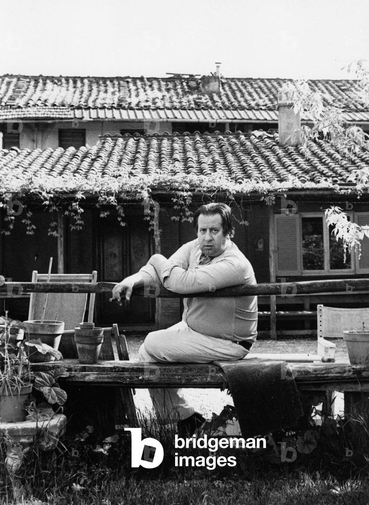 Tinto Brass sitting on a bench