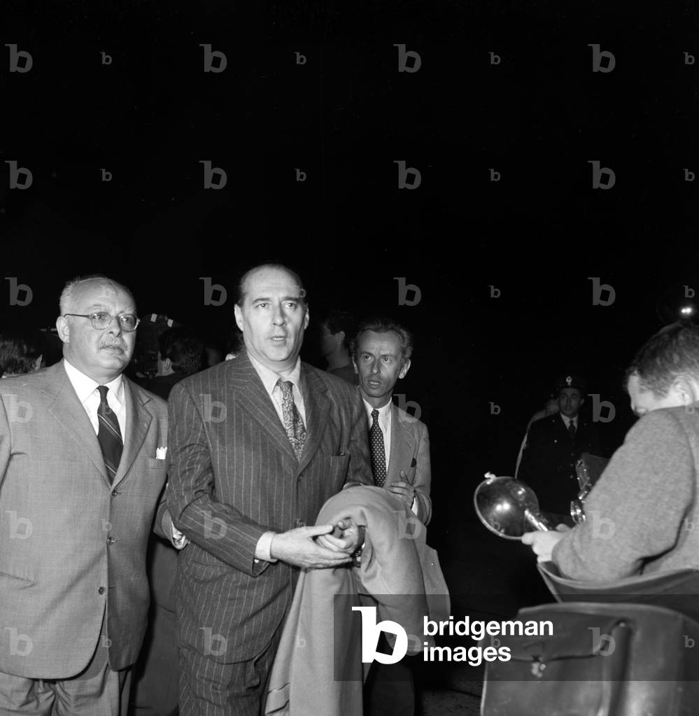 Roberto Rossellini at Ciampino airport, Italy, 1957 (b/w photo)