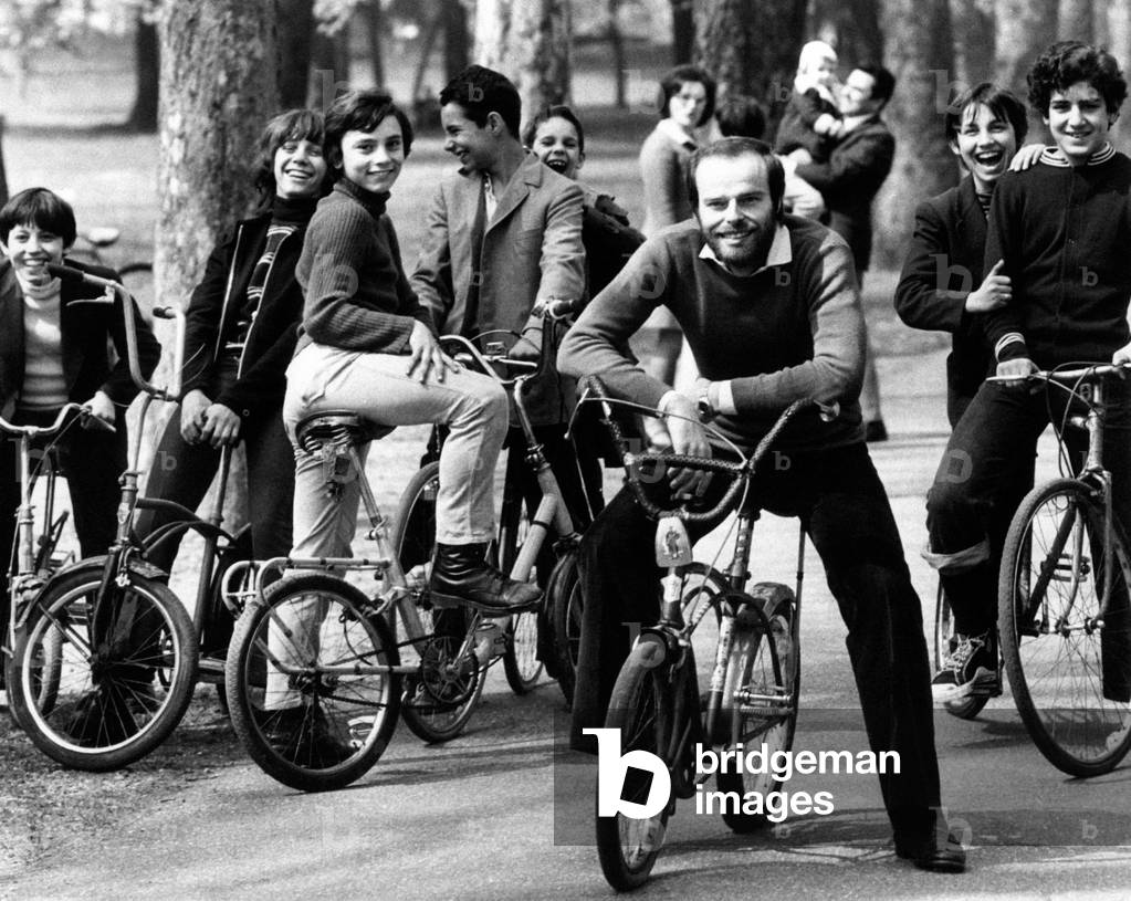 Dino smiling on a bicylce