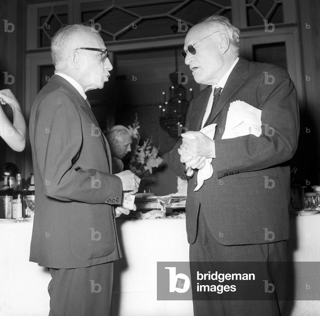 Fabio Tombari and Giuseppe Ungaretti talk at a party