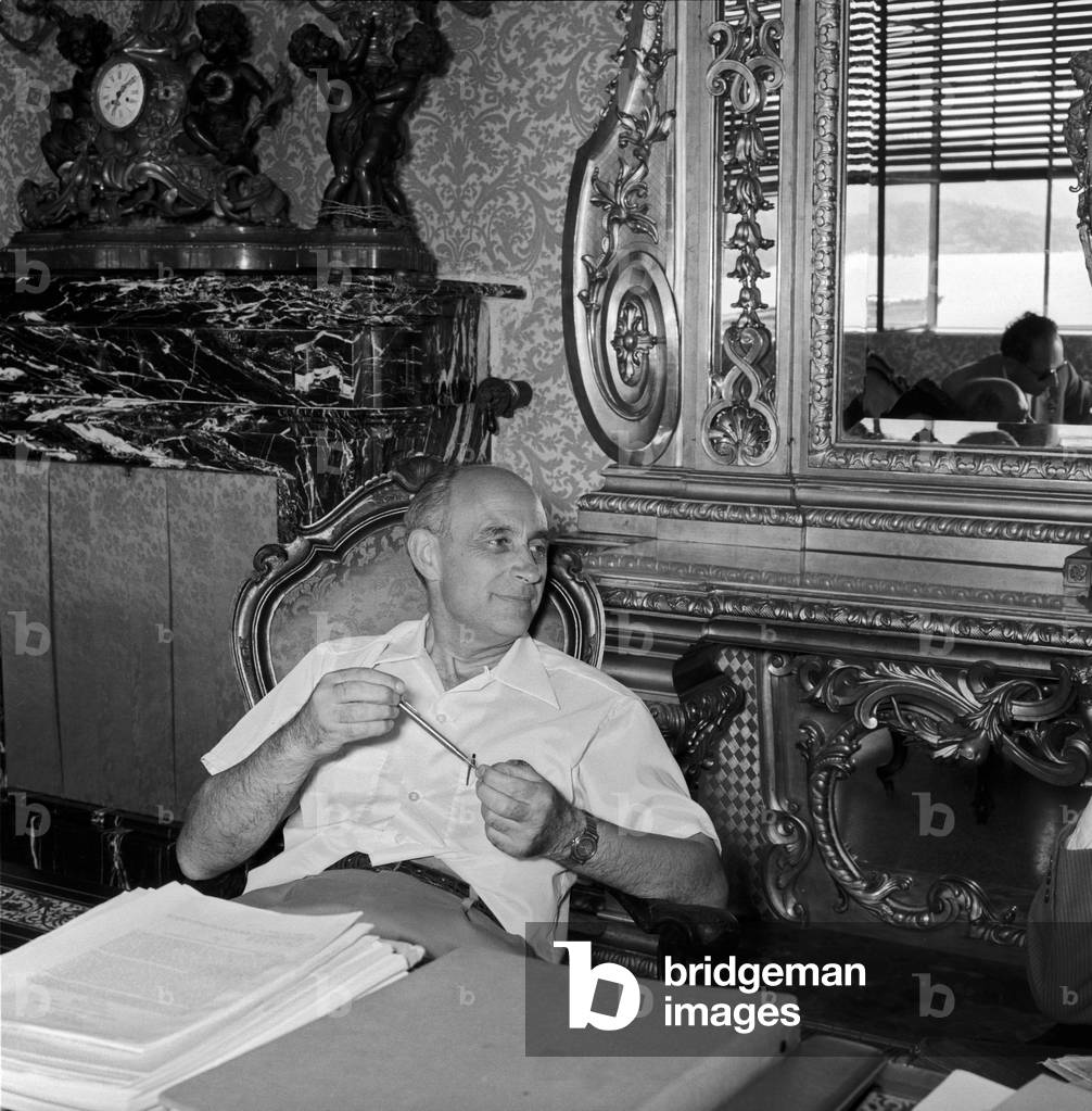 Enrico Fermi seated on a chair