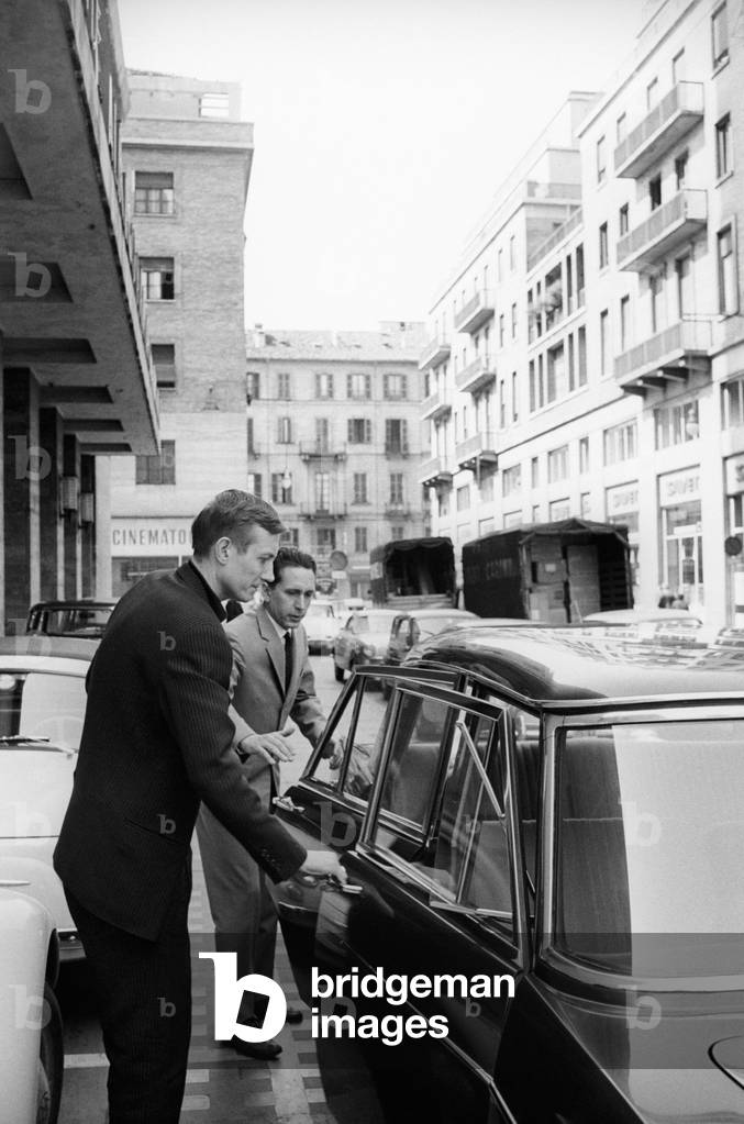 Yevgeny Yevtushenko mounting on a car