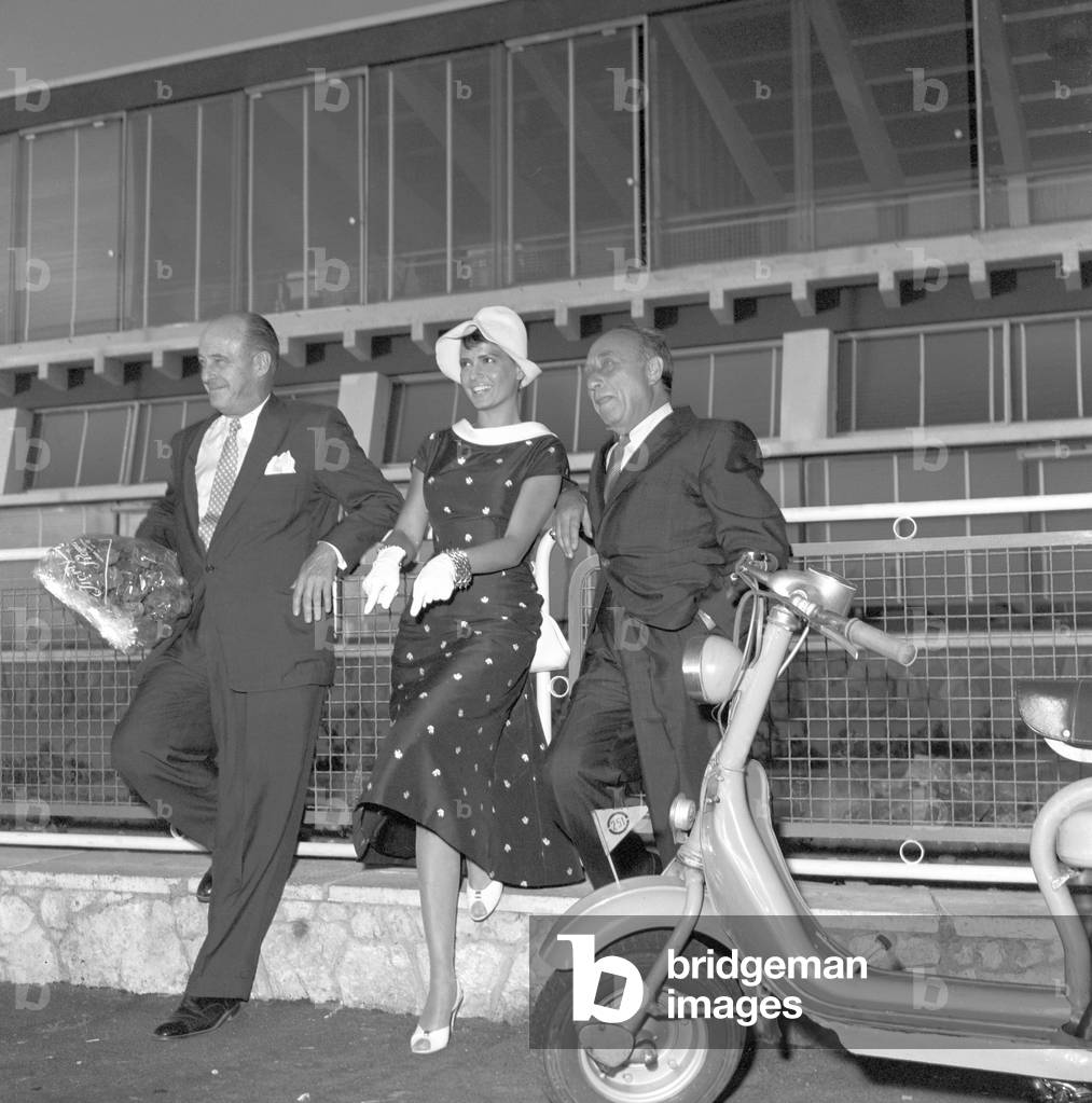 Joe Pasternak and Eva Bartok waiting for Dean Martin (b/w photo)