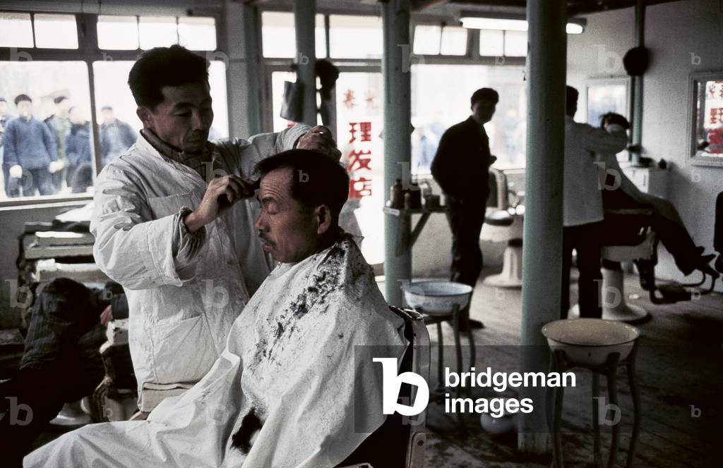 A barber at work in his shop, 1973 (photo)