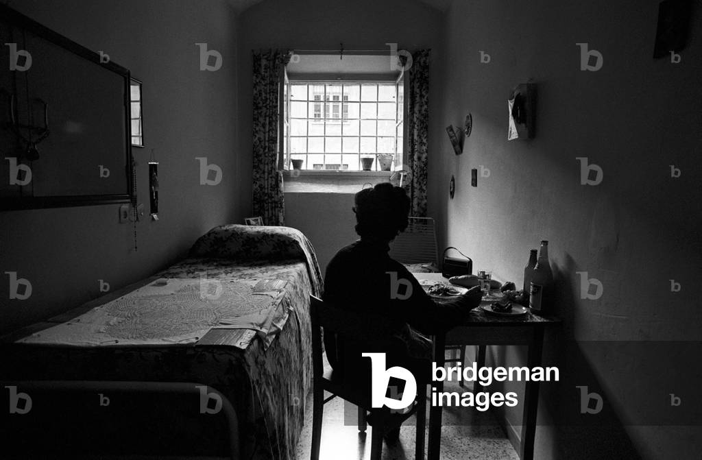 Prisoner eating in her cell
