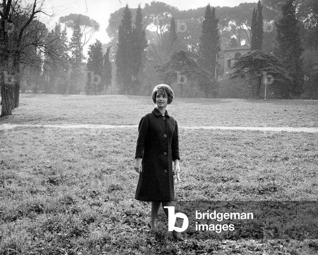Aba Cercato walking on the grass, in a park, 1961 (b/w photo)
