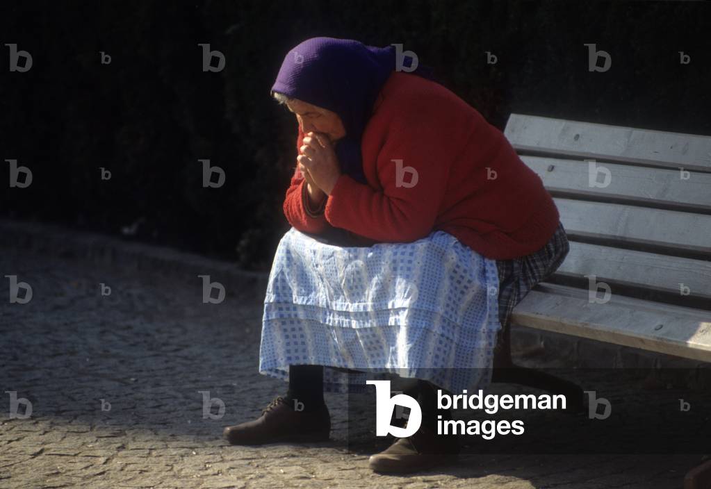 Elderly woman on a bench