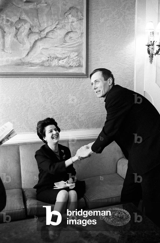 Yevgeny Yevtushenko shaking hands with a woman