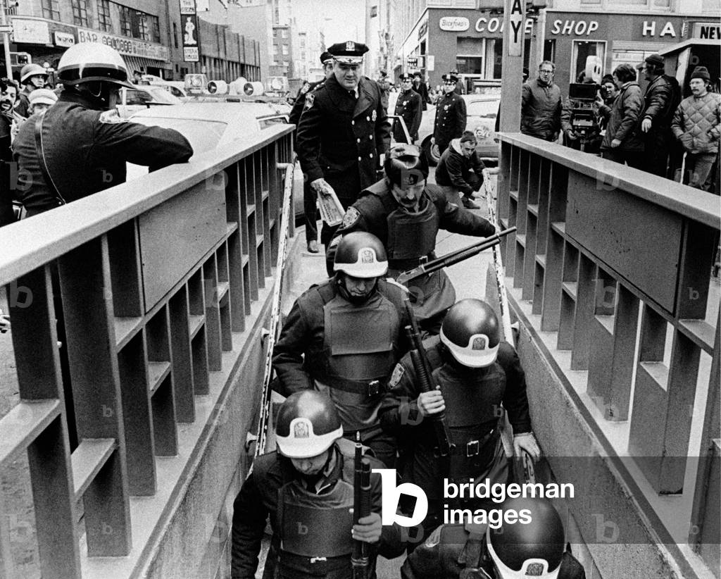 A group of policemen going down the stairs of the underground, New York, United States