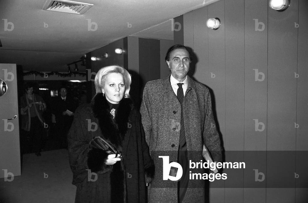 Pippo Baudo, Italian TV host, coming out of a club with his wife Katia, Italy, 1980 (b/w photo)