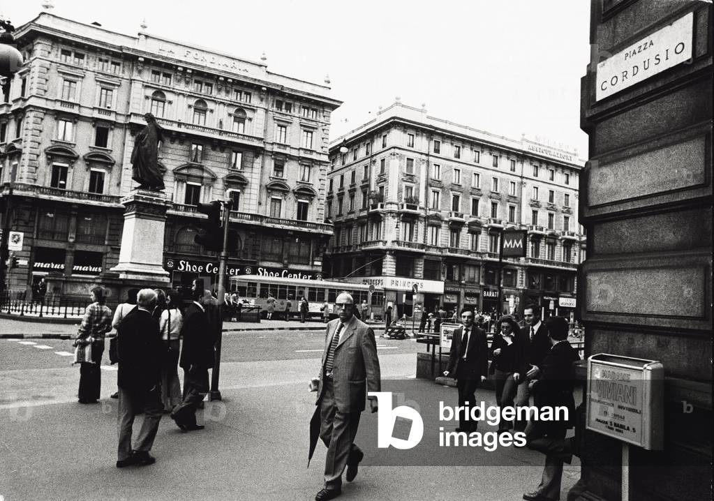 Passers-by and tram in Piazza Cordusio