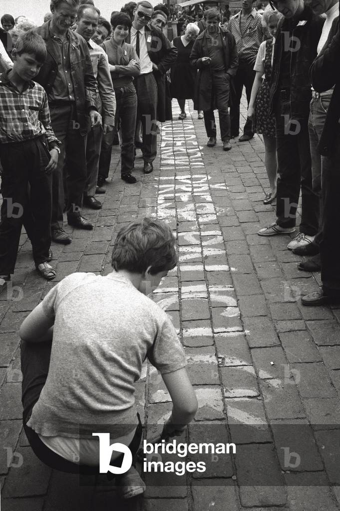 Prague: a boy is writing on the pavement