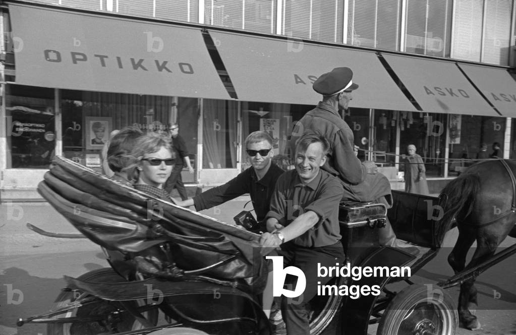 Some people posing seated in a coach, Finland, 1960s (b/w photo)