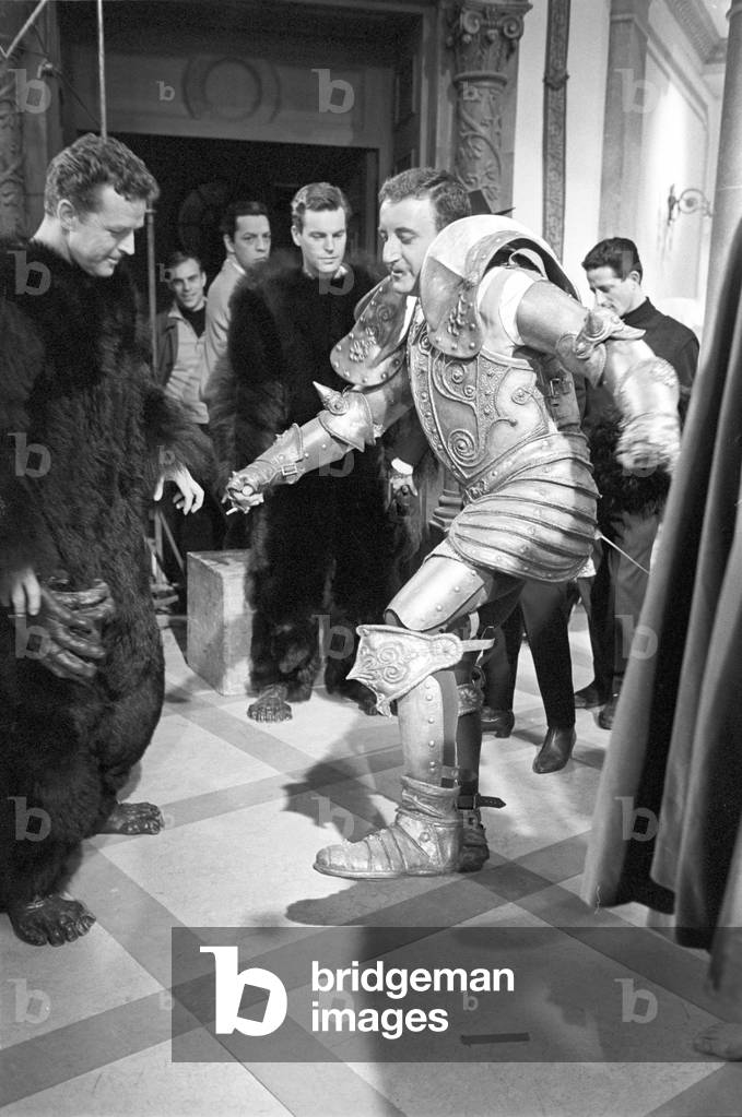 Peter Sellers walking wearing an armour, 1963 (b/w photo)