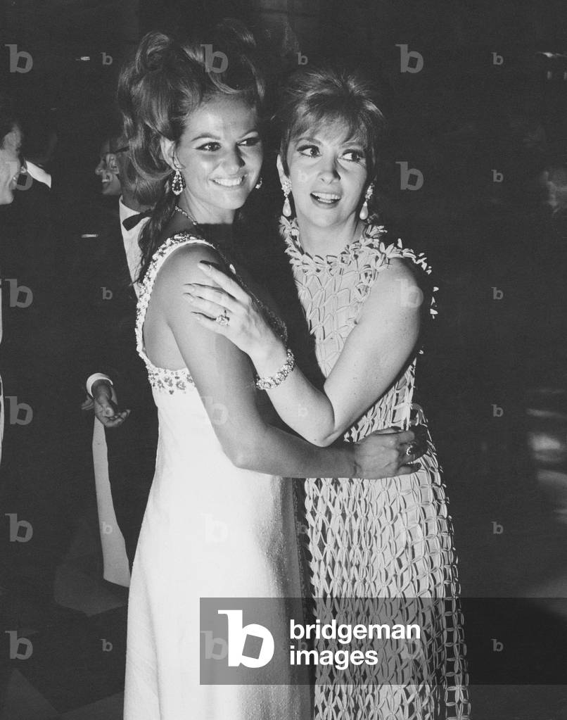 Claudia Cardinale and Gina Lollobrigida attending a party held by the Counts Cicogna, Venice, Italy