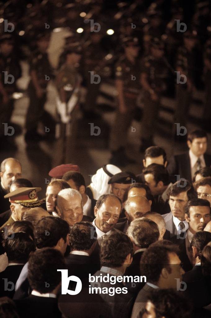 Anwar al-Sadat smiling surrounded by the crowd