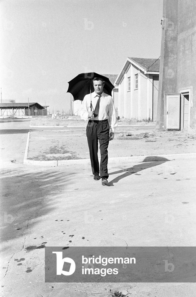 Marcello Mastroianni walking in Cinecittò, Italy, 1959 (b/w photo)
