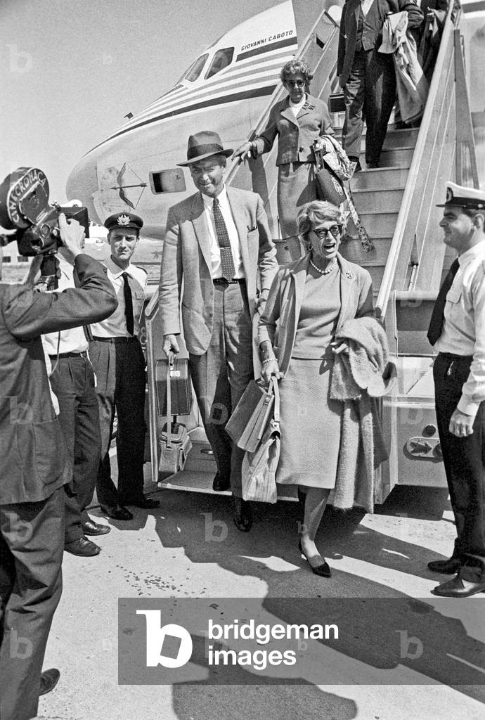 James Stewart and his wife Gloria Hatrick McLean arriving at Fiumicino Airport, Fiumicino, Italy, 1961 (b/w photo)