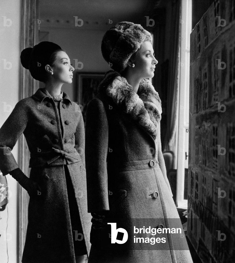 Two models wearing elegant coats