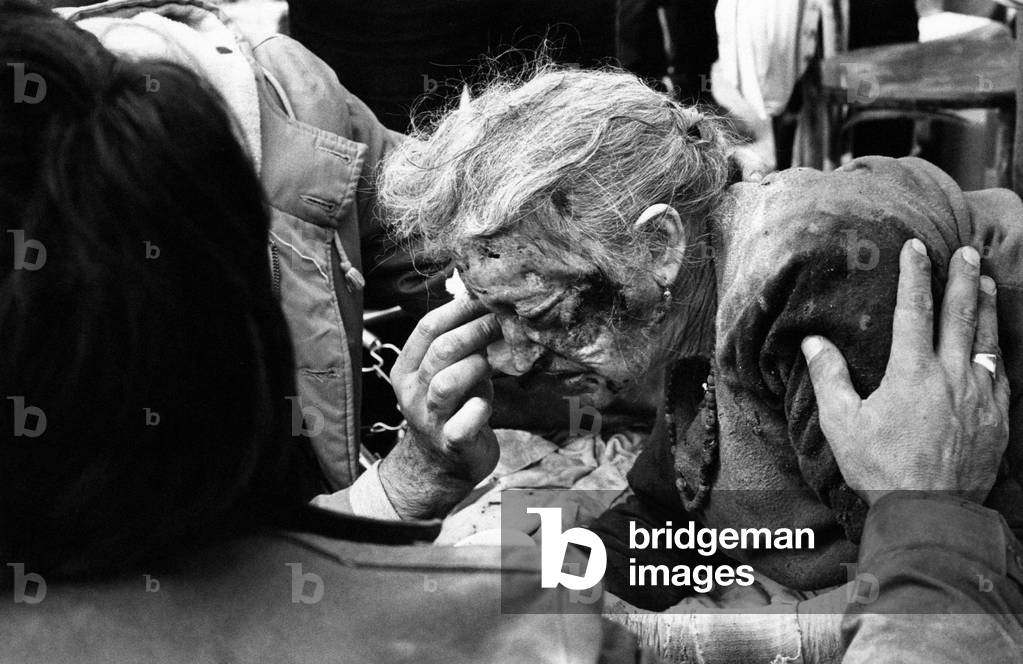 An old woman getting first aid care, Sant'Angelo-dei-Lombardi, Italy, 1980