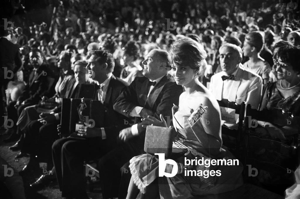 Sophia Loren with a prize between the public, 1960 (b/w photo)