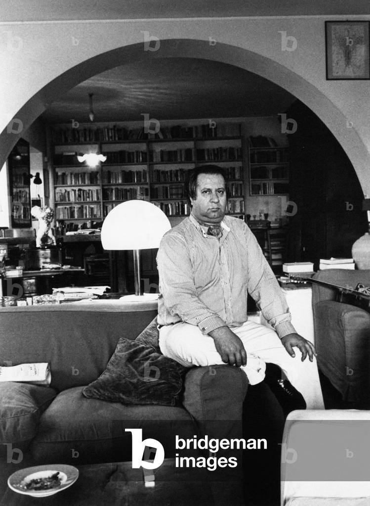 Tinto Brass sitting on a couch