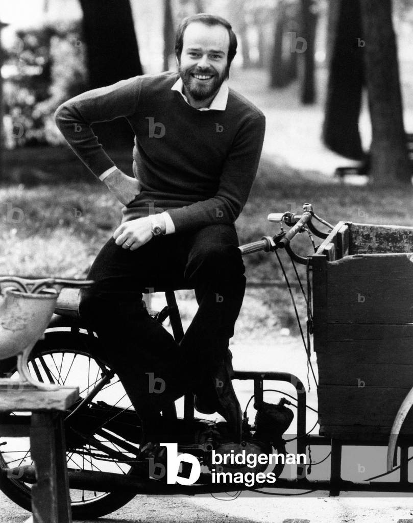 Dino smiling on a moped